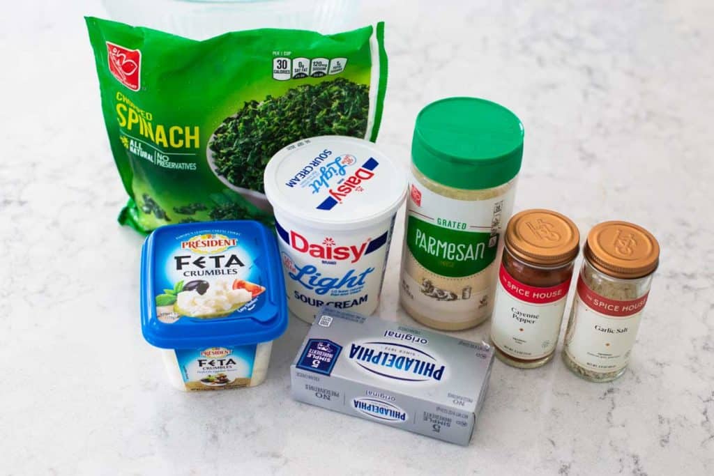 The cold spinach dip ingredients are on a kitchen counter.