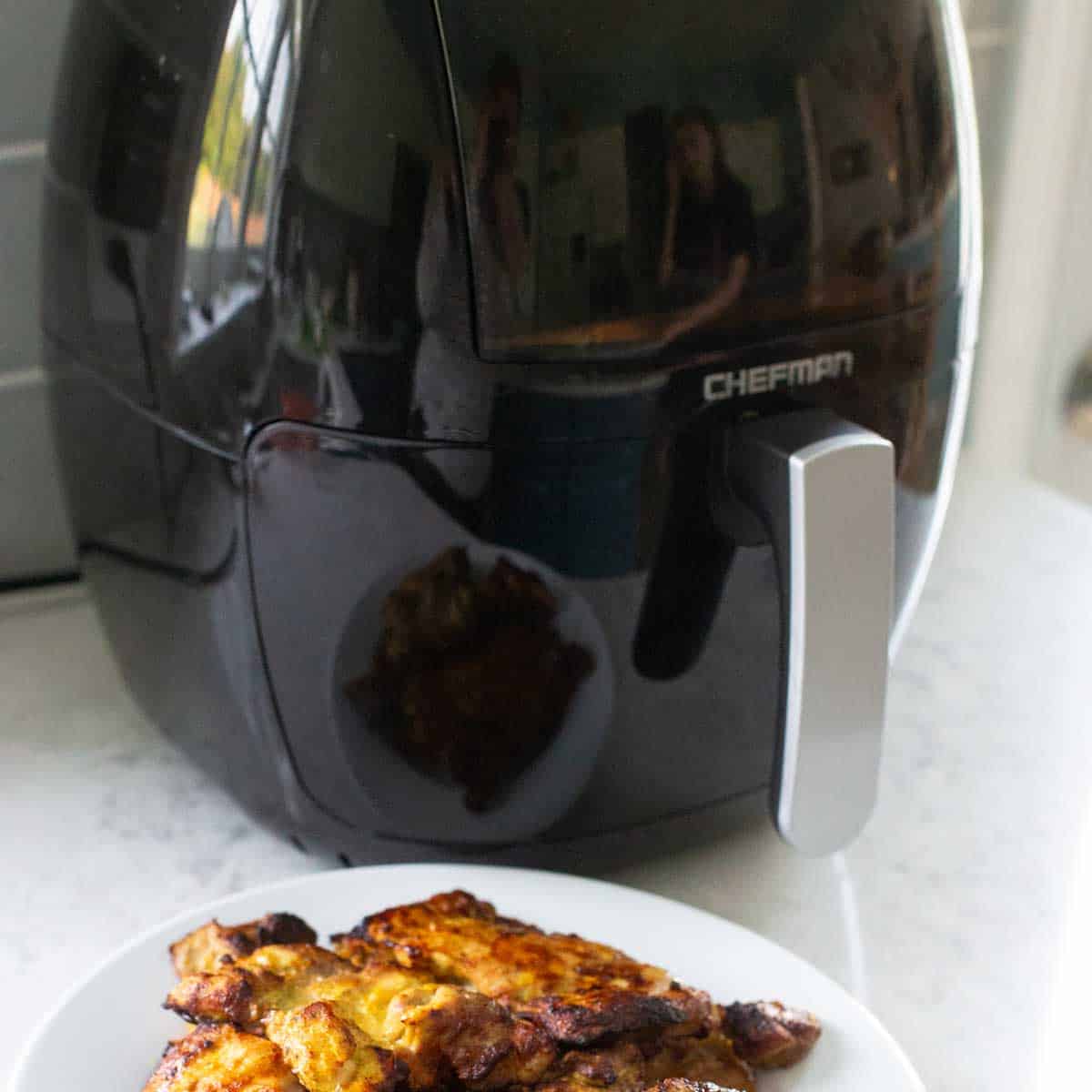 An air fryer sits on the kitchen counter.