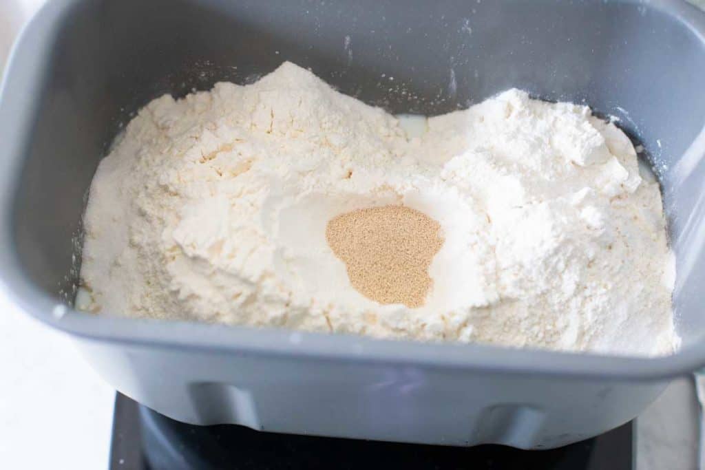 The dry ingredients for the Italian bread have been added to the bread machine pan.