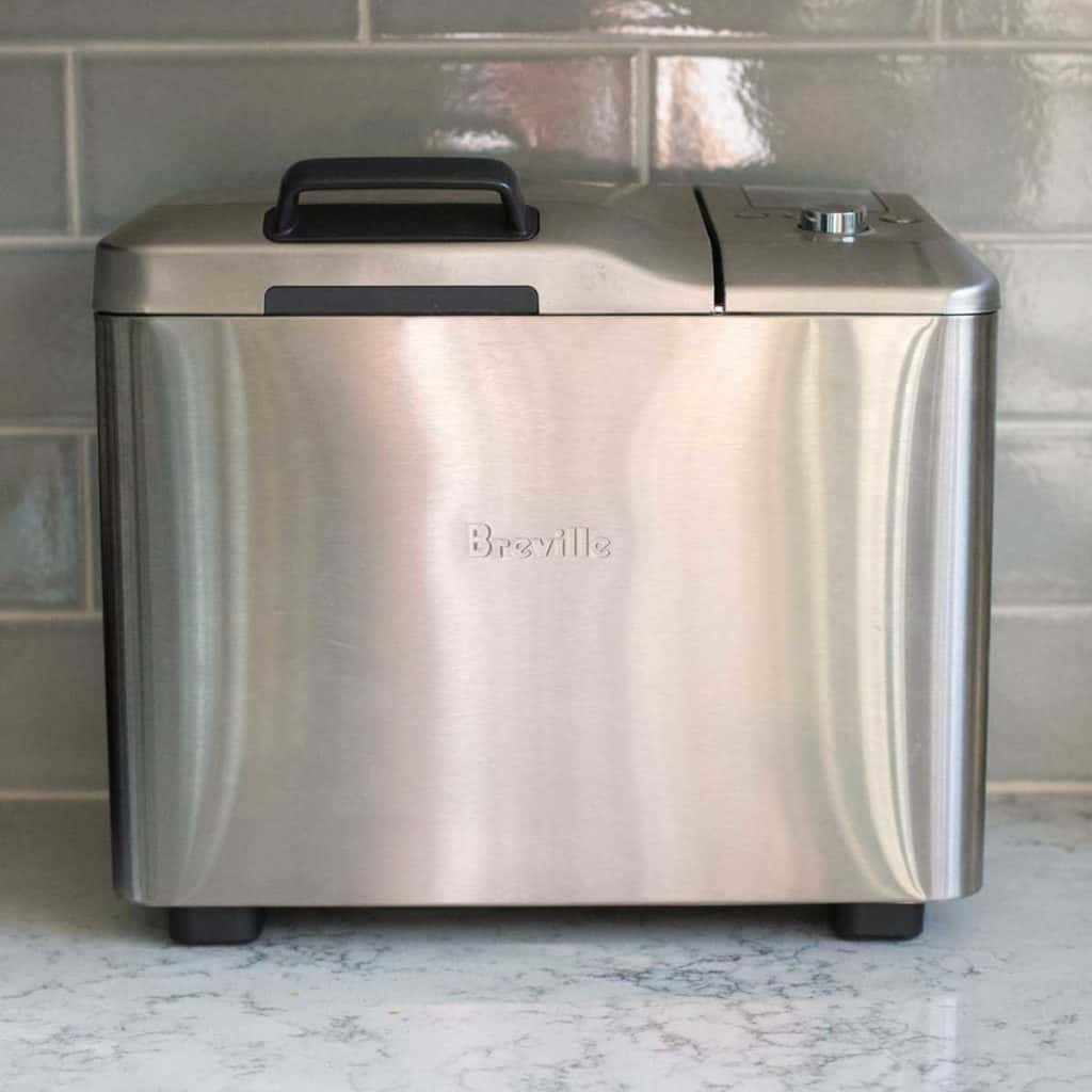 The Breville bread machine sits on a kitchen counter.