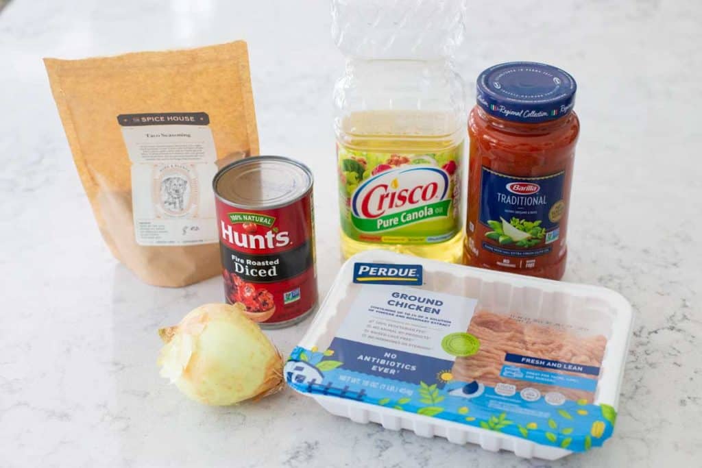 The ingredients for crockpot chicken taco chili sit on a kitchen counter.