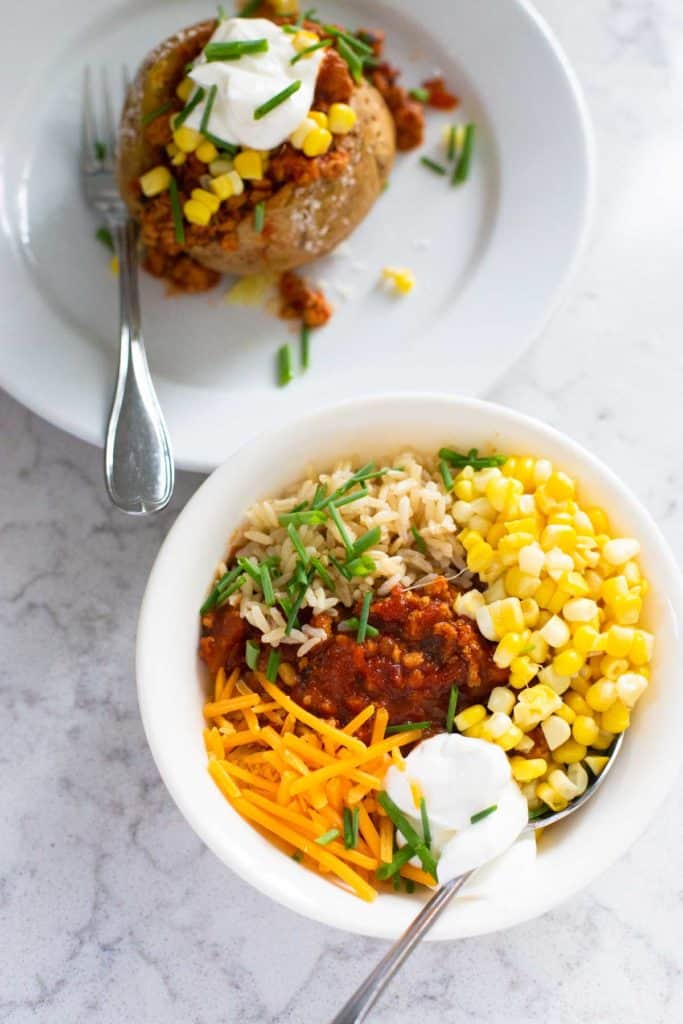 The chili has been used to stuff a baked potato and also make a homemade burrito bowl with corn, shredded cheese, and sour cream.