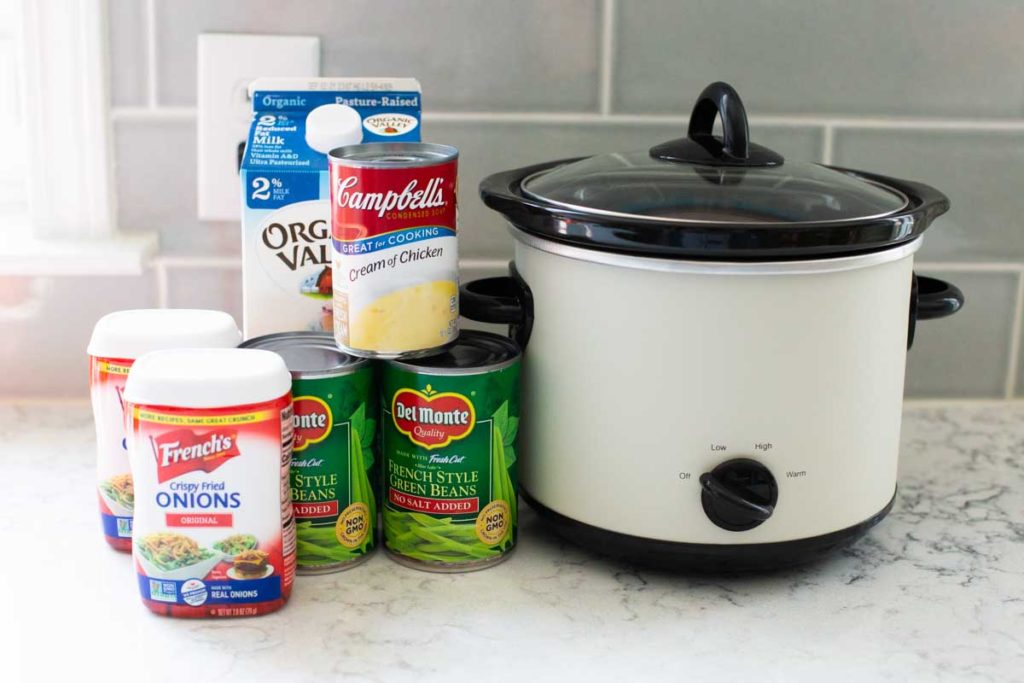 The ingredients for the green bean casserole sit on a counter next to the Crockpot.