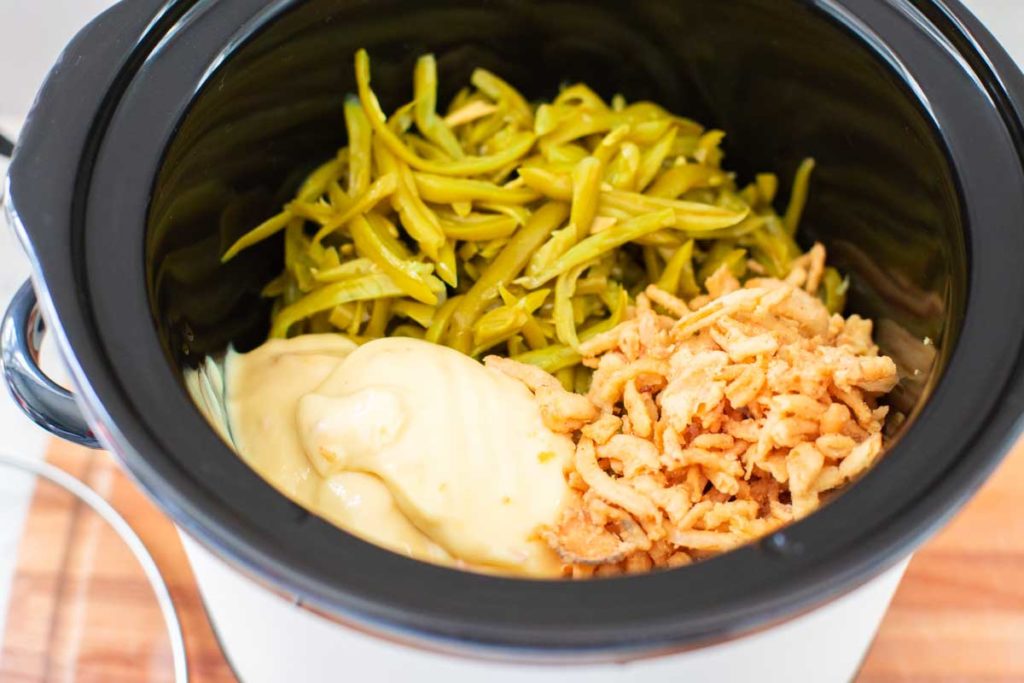 The ingredients for the green bean casserole are inside the crockpot.