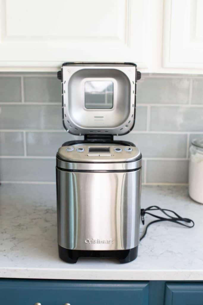 The Cuisinart bread machine has the lid open.