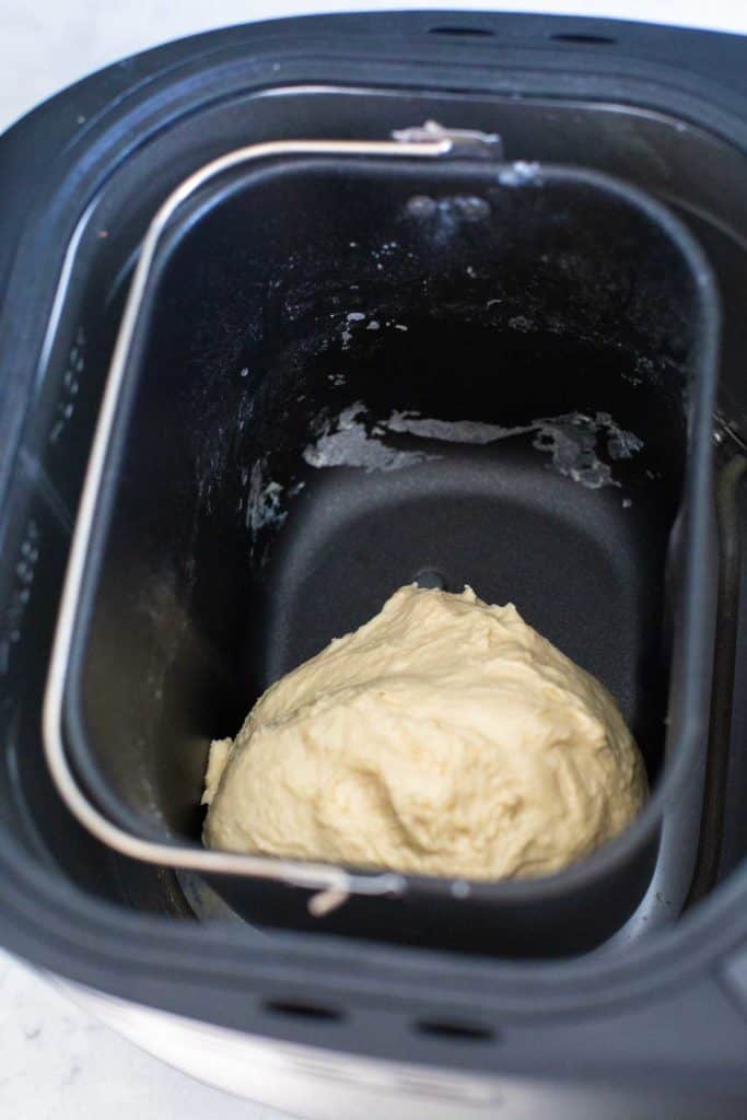 The dough ball is pushed to one side and doesn't fill the bread pan evenly.