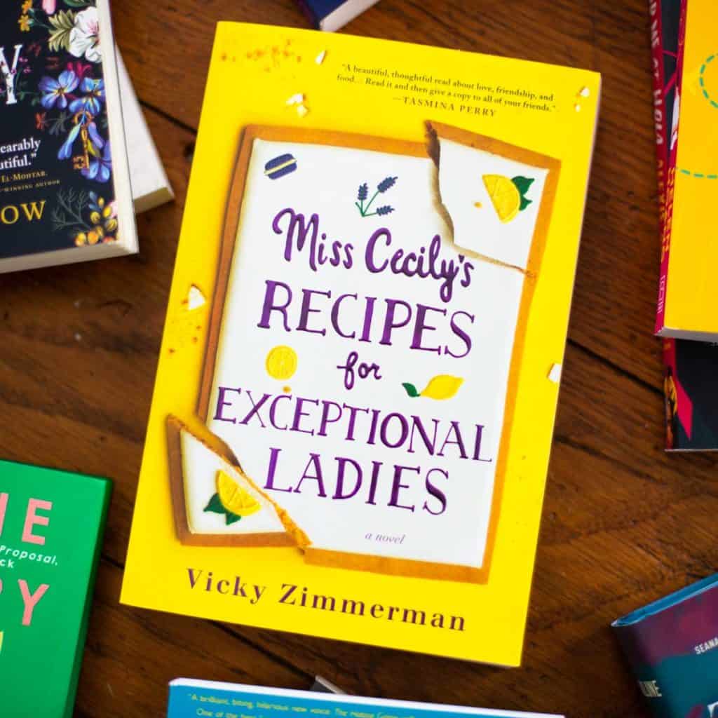 A copy of Miss Cecily's Recipes for Exceptional Ladies sits on a table.