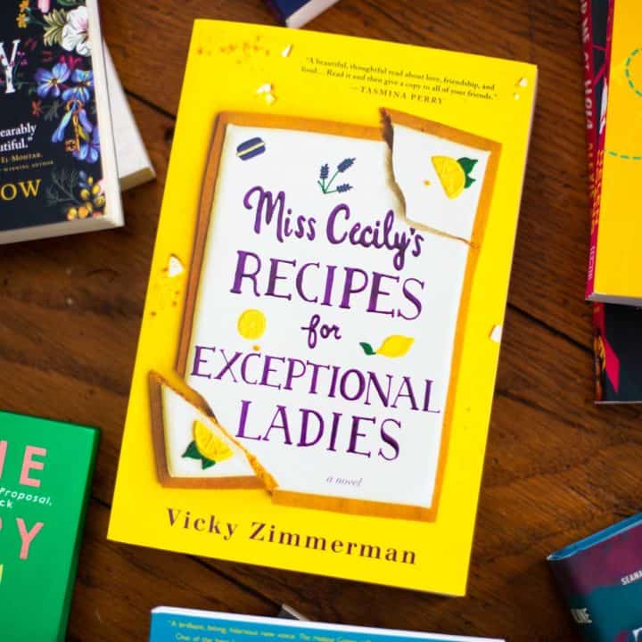 A copy of Miss Cecily's Recipes for Exceptional Ladies sits on a table.