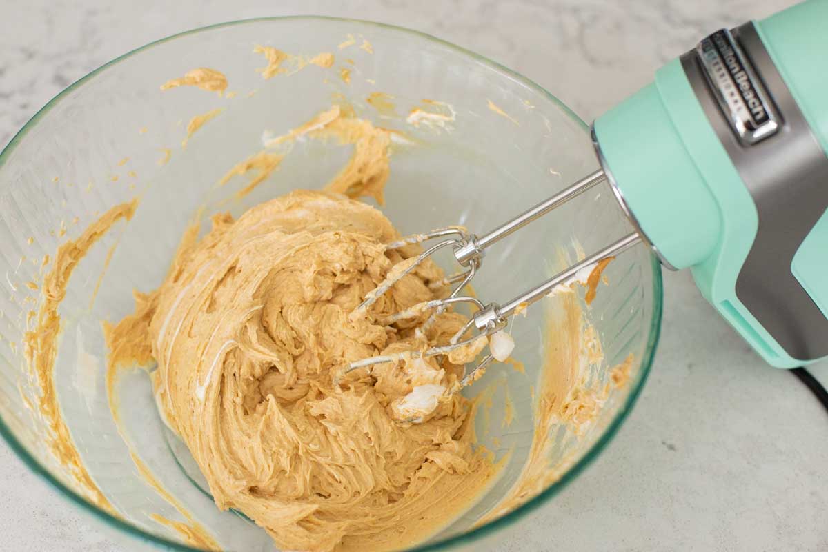 The peanut butter dip has been stirred together in the mixing bowl.