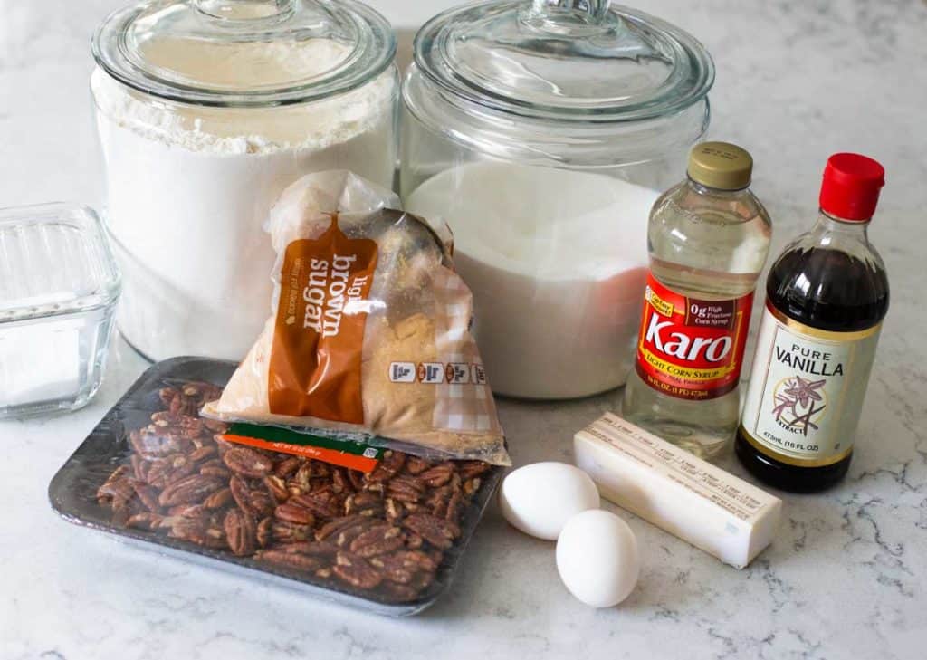 The ingredients for pecan pie bars sits on a counter.