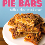 A cake plate with a stack of pecan bars on top. Caption reads: Pecan Pie Bars with a shortbread crust"