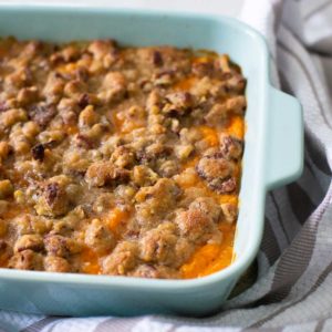 A baking dish filled with the finished sweet potato casserole with pecan topping.