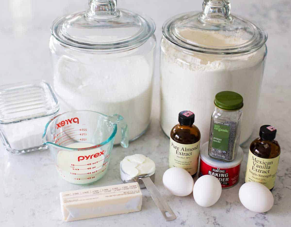 The ingredients for almond poppy seed bread are on the kitchen counter.