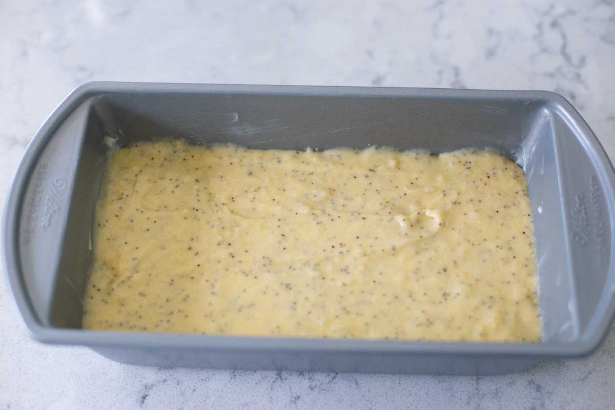 The finished poppyseed batter has been spread into a bread pan for baking.