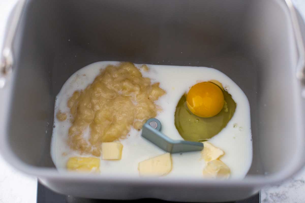 The wet ingredients for the banana bread are in the bread machine bread pan.