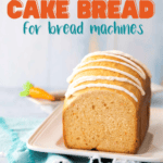 The baked carrot cake bread has been sliced so you can see the inside and is covered with a cream cheese drizzle.