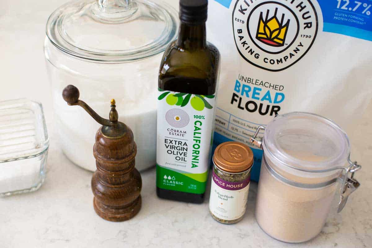 The ingredients for the bread machine focaccia are on the kitchen counter.