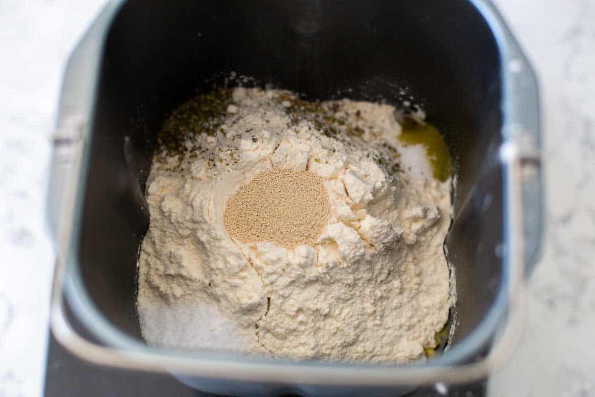 The dry ingredients for the focaccia are in the bread machine bread pan.