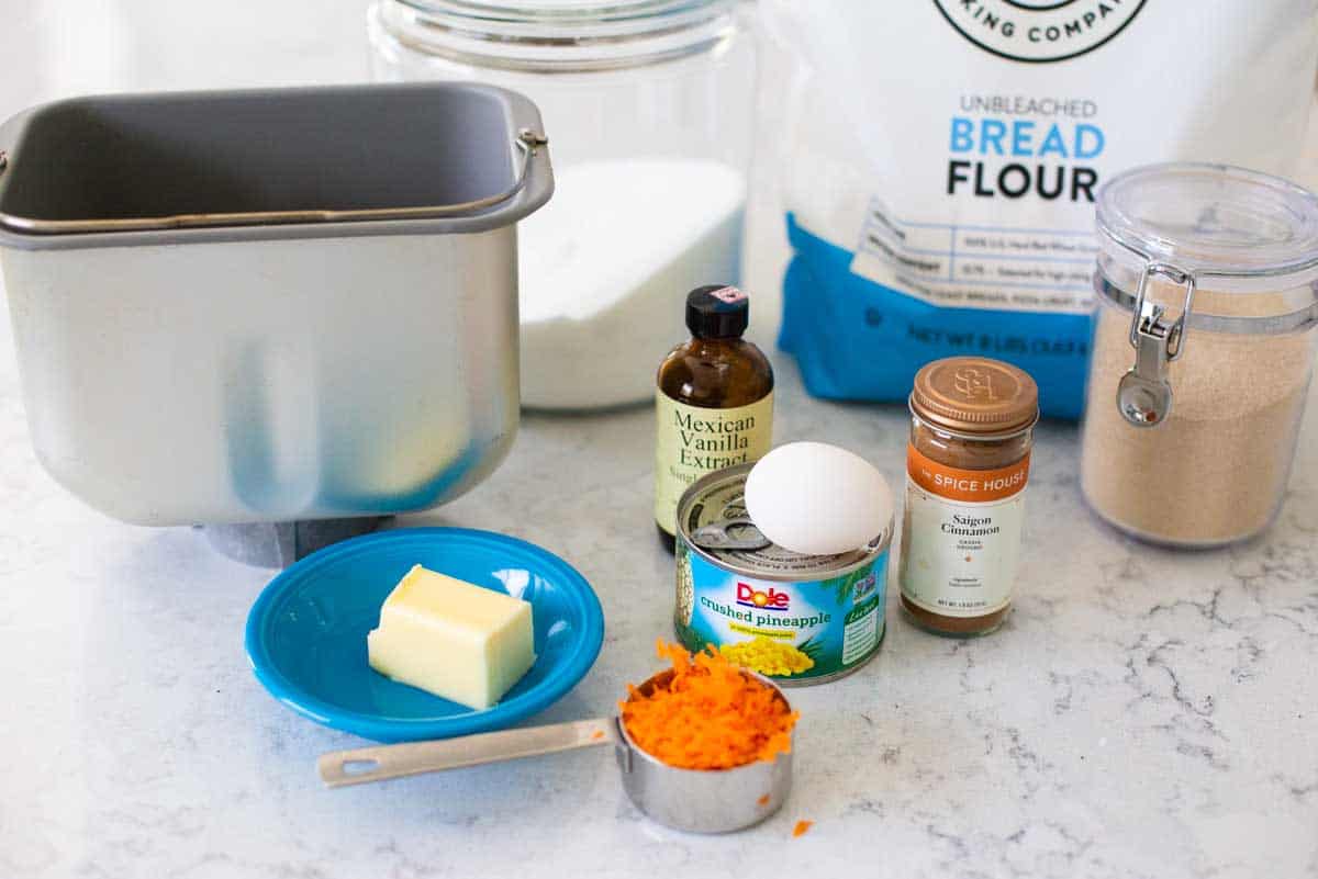 The ingredients for the carrot cake bread for bread machines sits on a counter.