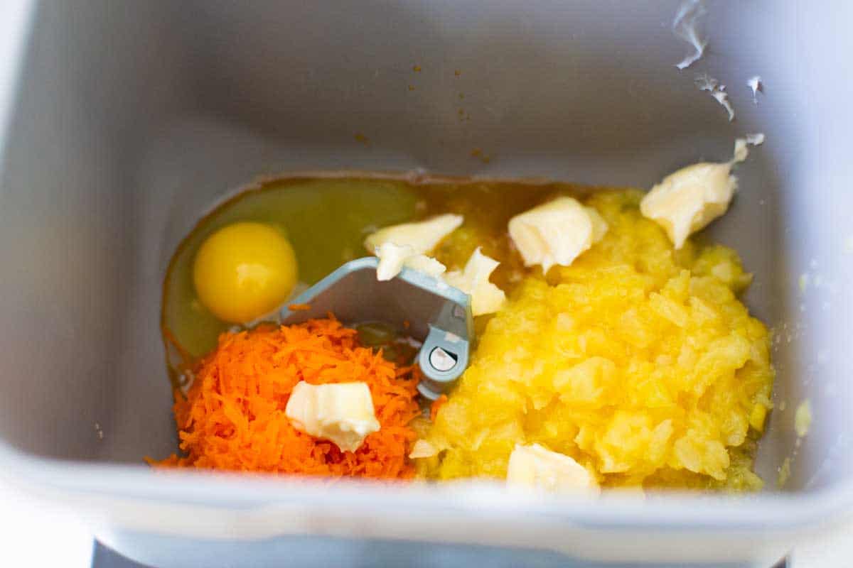 The wet ingredients for the carrot cake bread are in the bread machine bread pan.