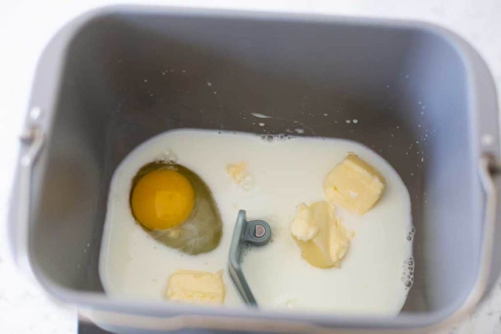 The wet ingredients in the bread machine bread pan.