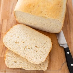 A loaf of sourdough bread from the bread machine has been sliced to show the texture of the bread.