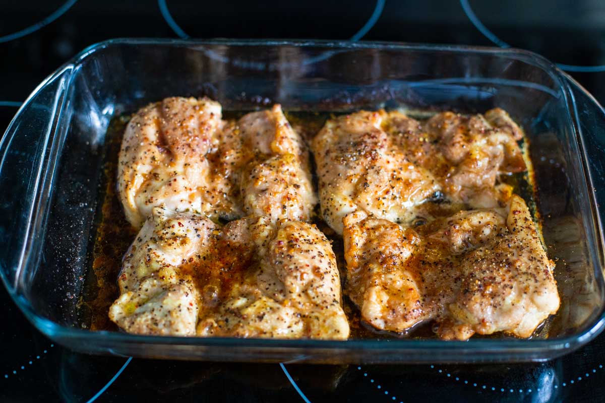 The chicken thighs have been sprinkled with pepper and baked for 15 minutes, they are still pale.