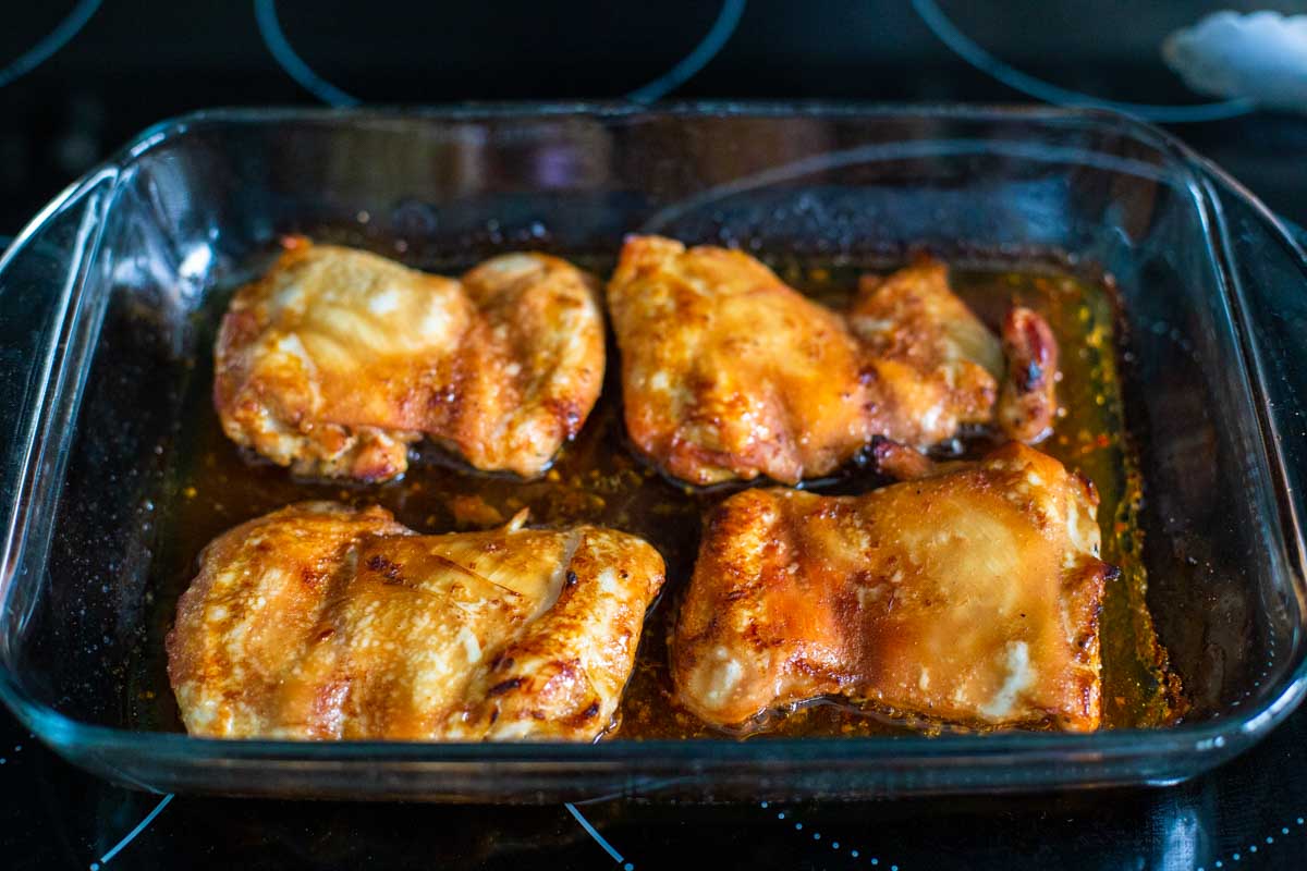 The chicken thighs have been baked for 45 minutes and are now golden brown and slightly crispy on the edges.