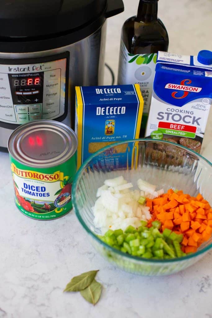 The ingredients for the ground turkey soup sit on a counter next to the Instant Pot.