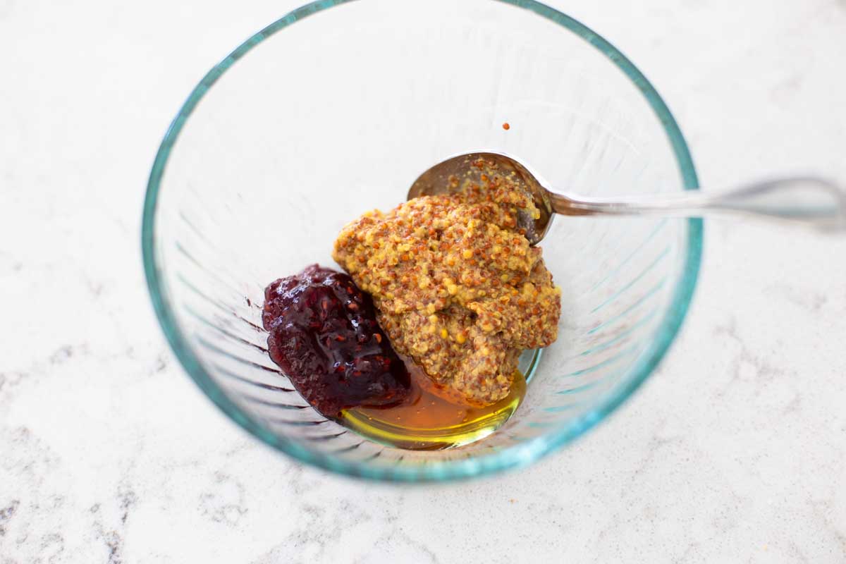 The ingredients for the raspberry mustard are in a mixing bowl.