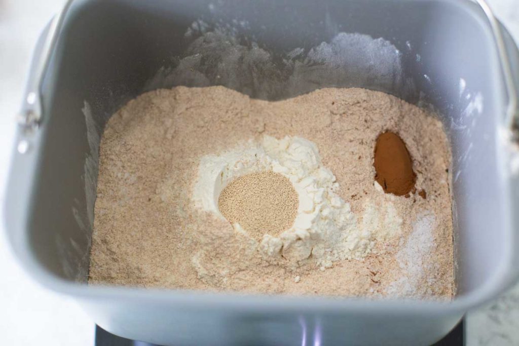 The wet ingredients for the brown bread have been put in the bottom of the bread machine bread pan on top of the wet.