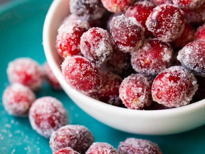 A bowl of sugared cranberries up close so you can see the sparkly sugar.