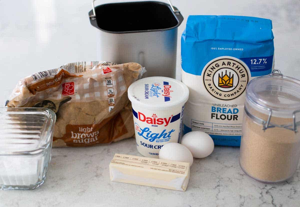 The ingredients to make crescent dinner rolls in a bread maker are on the counter.