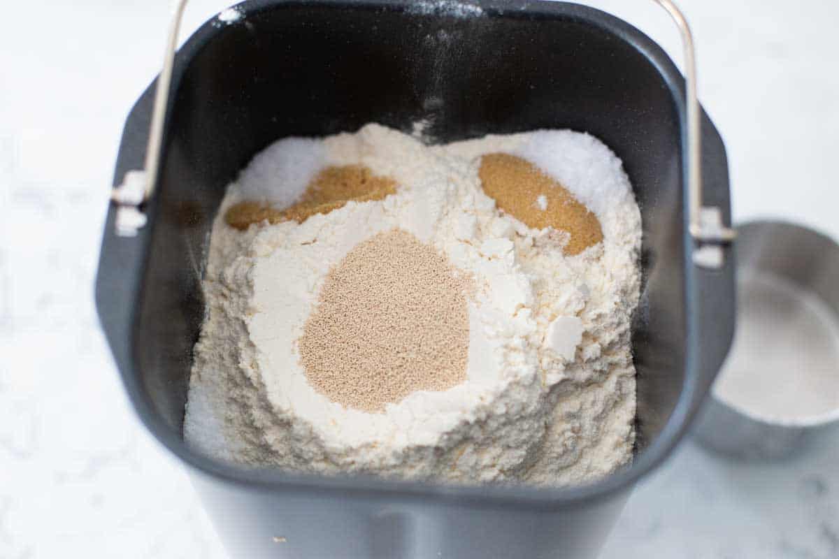 The dry ingredients are added to the bread machine baking pan