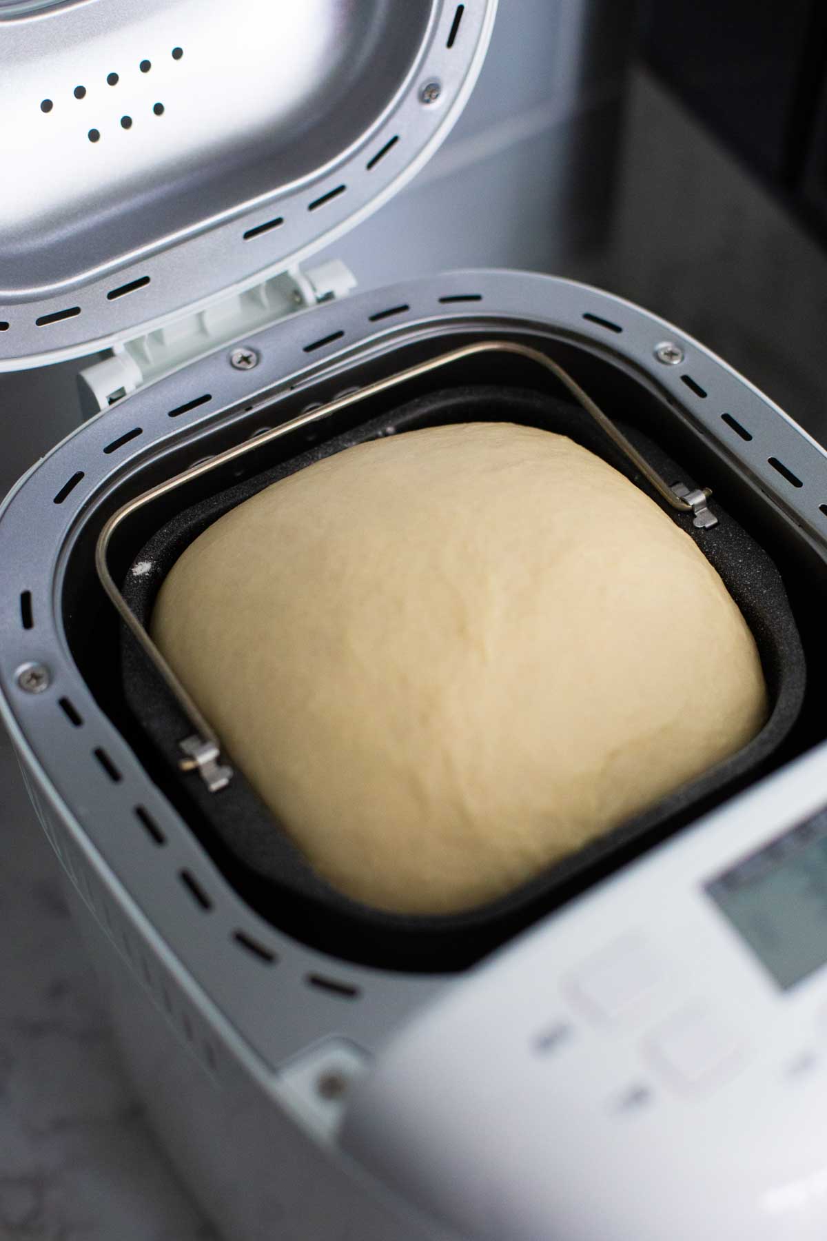 The dinner roll dough has risen in the bread machine.