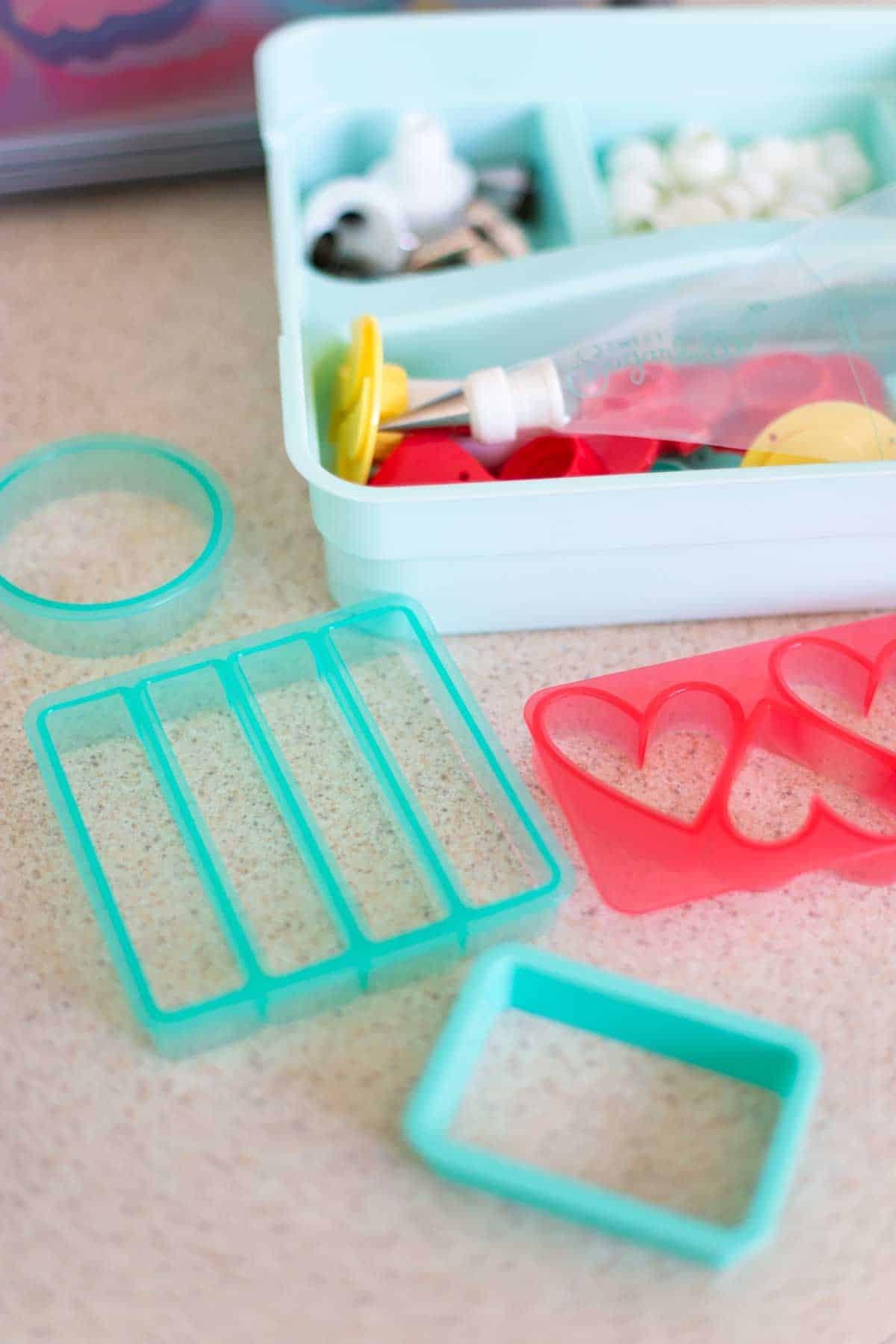 A collection of cookie cutters are on a kitchen counter.