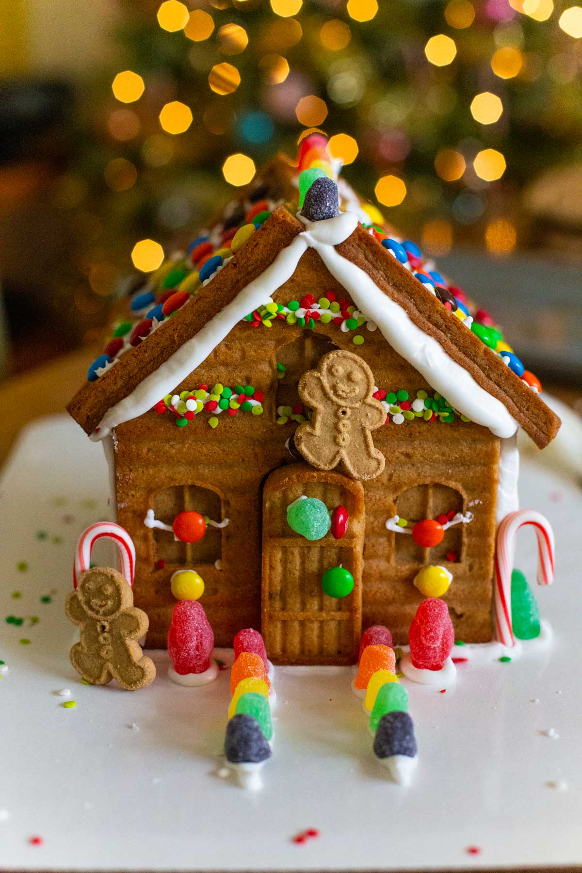 Another example of how to decorate a gingerbread house has a gumdrop pathway and dancing gingerbread boy cookies.