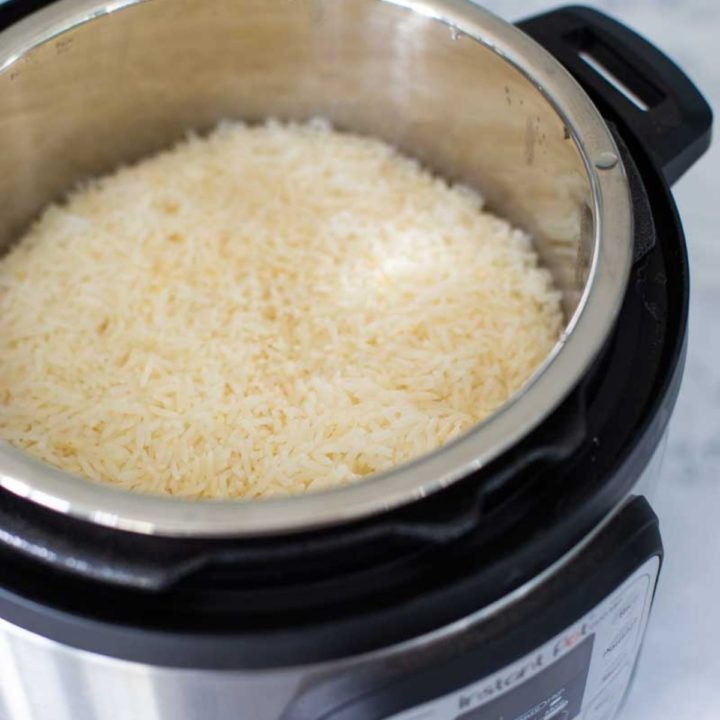 Instant Pot is filled with cooked white jasmine rice.