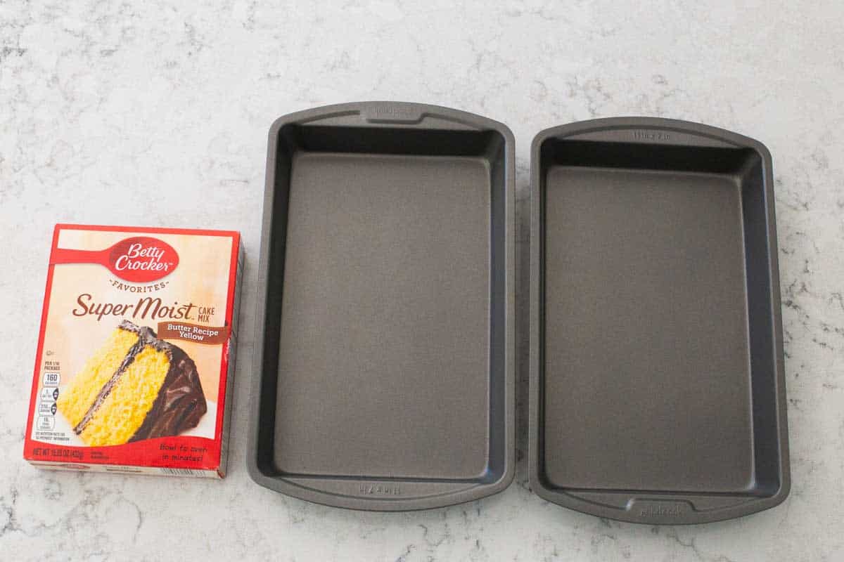 A close up of the cake pans and box cake mix used to make the monster cake.