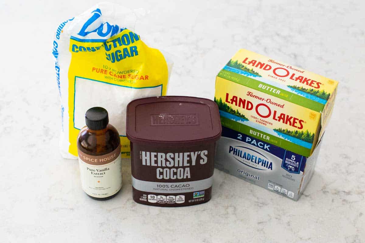 Ingredients for cream cheese frosting are on the counter.