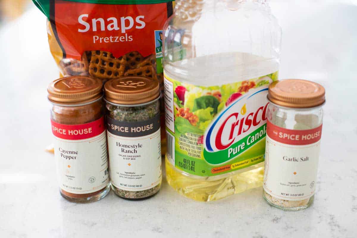 The ingredients for making the seasoned pretzels recipe are on the counter.