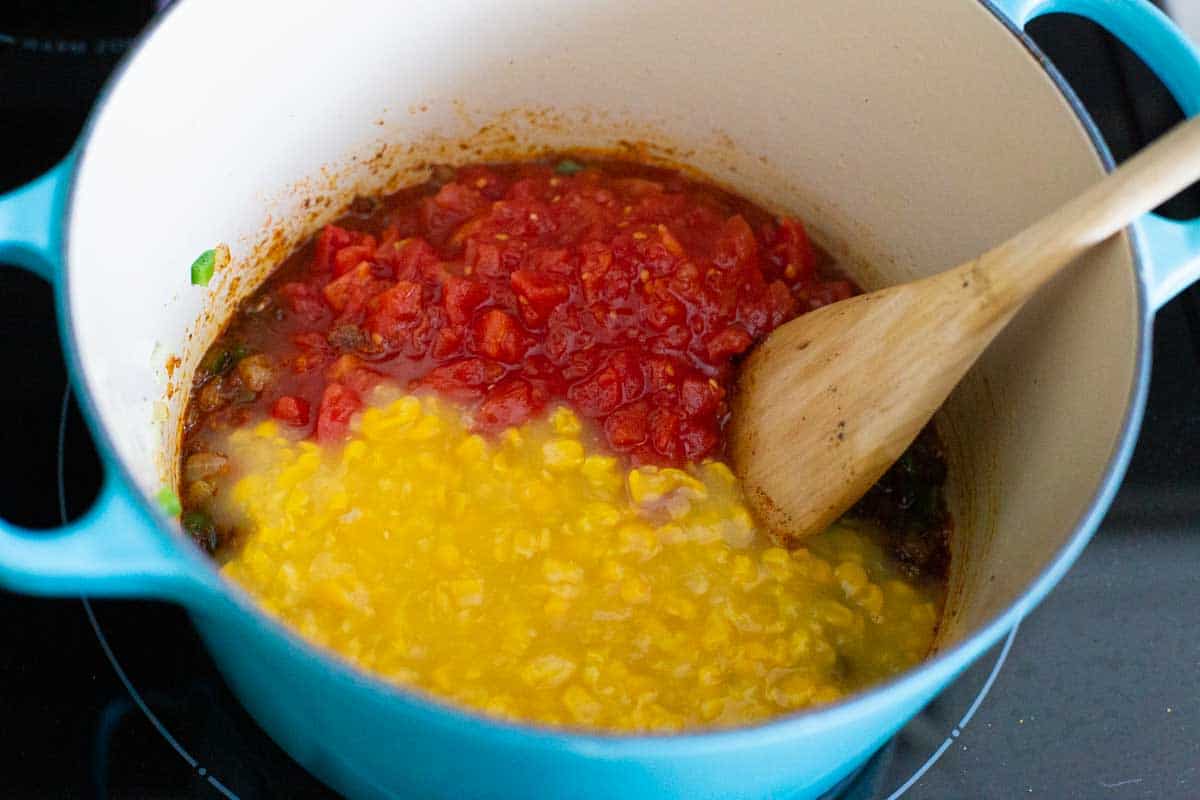 The canned tomatoes and creamed corn have been added.