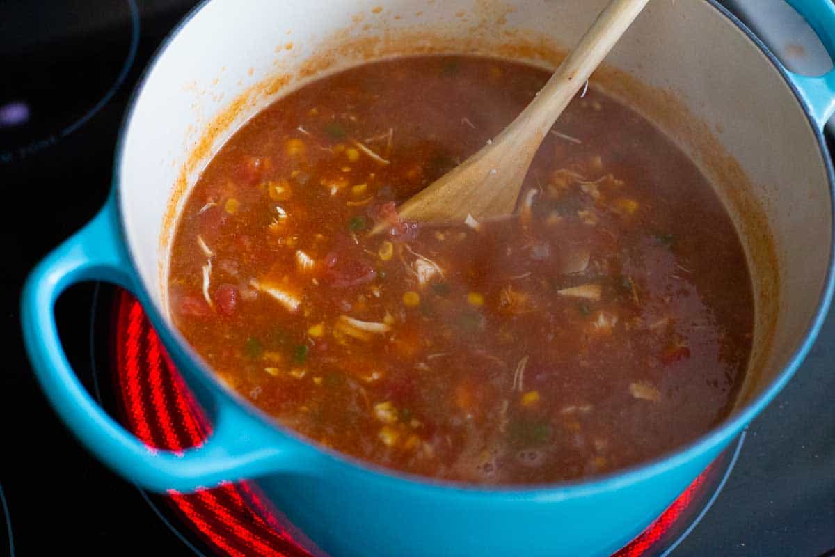 The finished soup is stirred together in the soup pot on the stove.