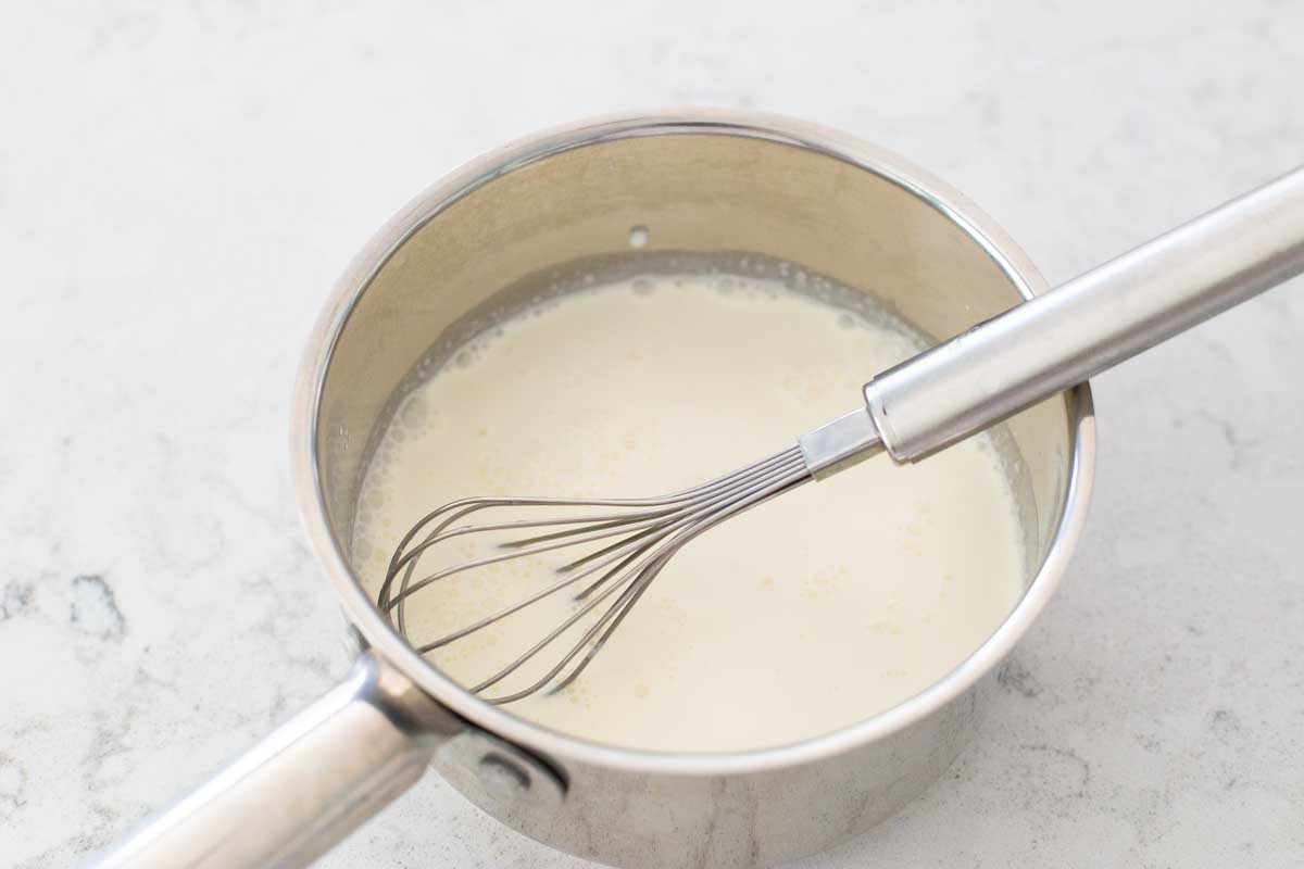 The cream and sugar have been whisked together in a small saucepan.