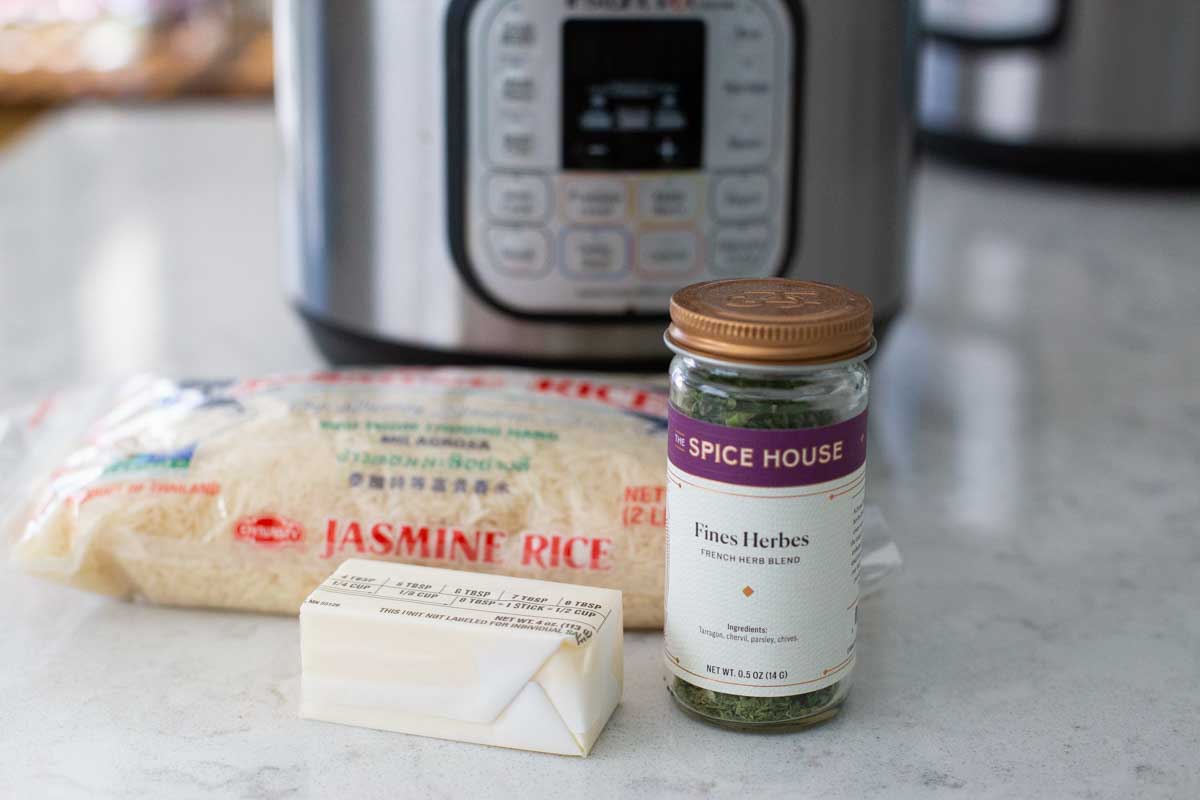 The ingredients for herb butter rice are on the counter in front of an Instant Pot.