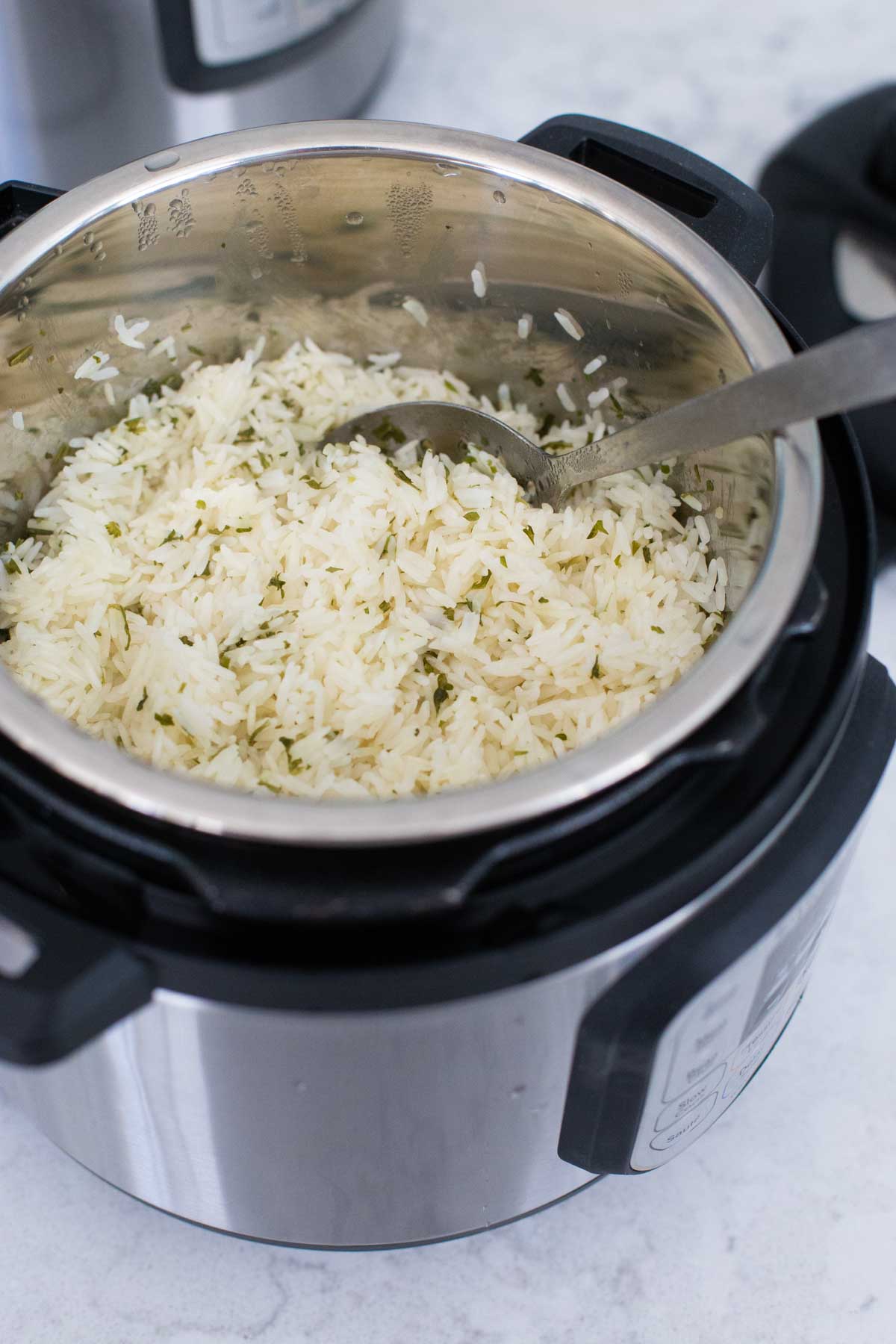 The finished herb butter rice is inside the Instant Pot, ready for serving.