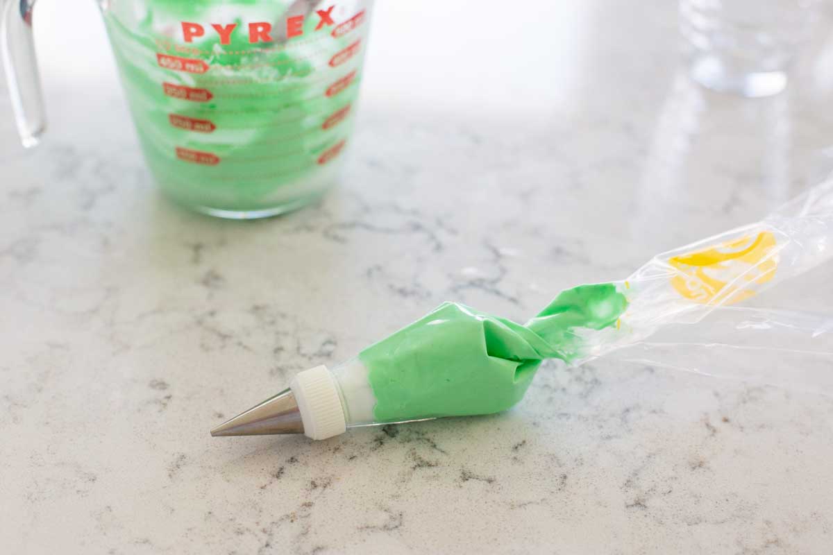 Green royal icing has been added to a piping bag.