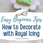 A simple tree-shaped sugar cookie is being iced green with white polka dots using royal icing.