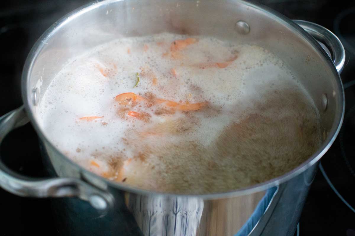 The water should be heavy boiling again before you set the timer for the shrimp.