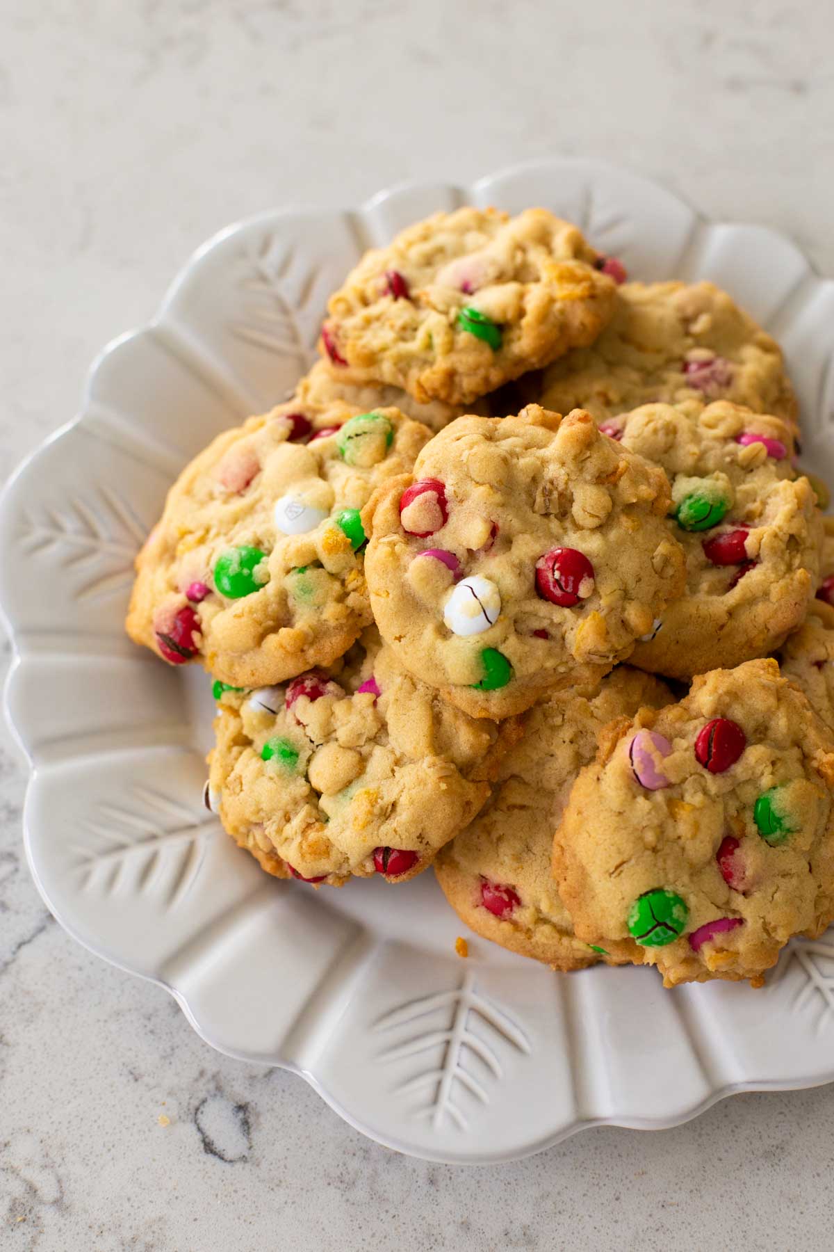 A plate of baked M&M cornflake cookies are ready for eating.